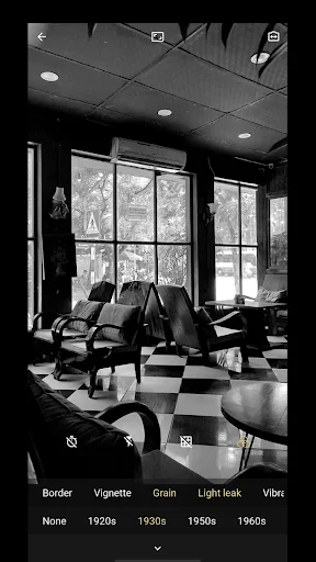 Black and white office scene with vintage 8mm filters displayed: Border, Vignette, Grain, Light leak, and decade options from 1920s-1960s